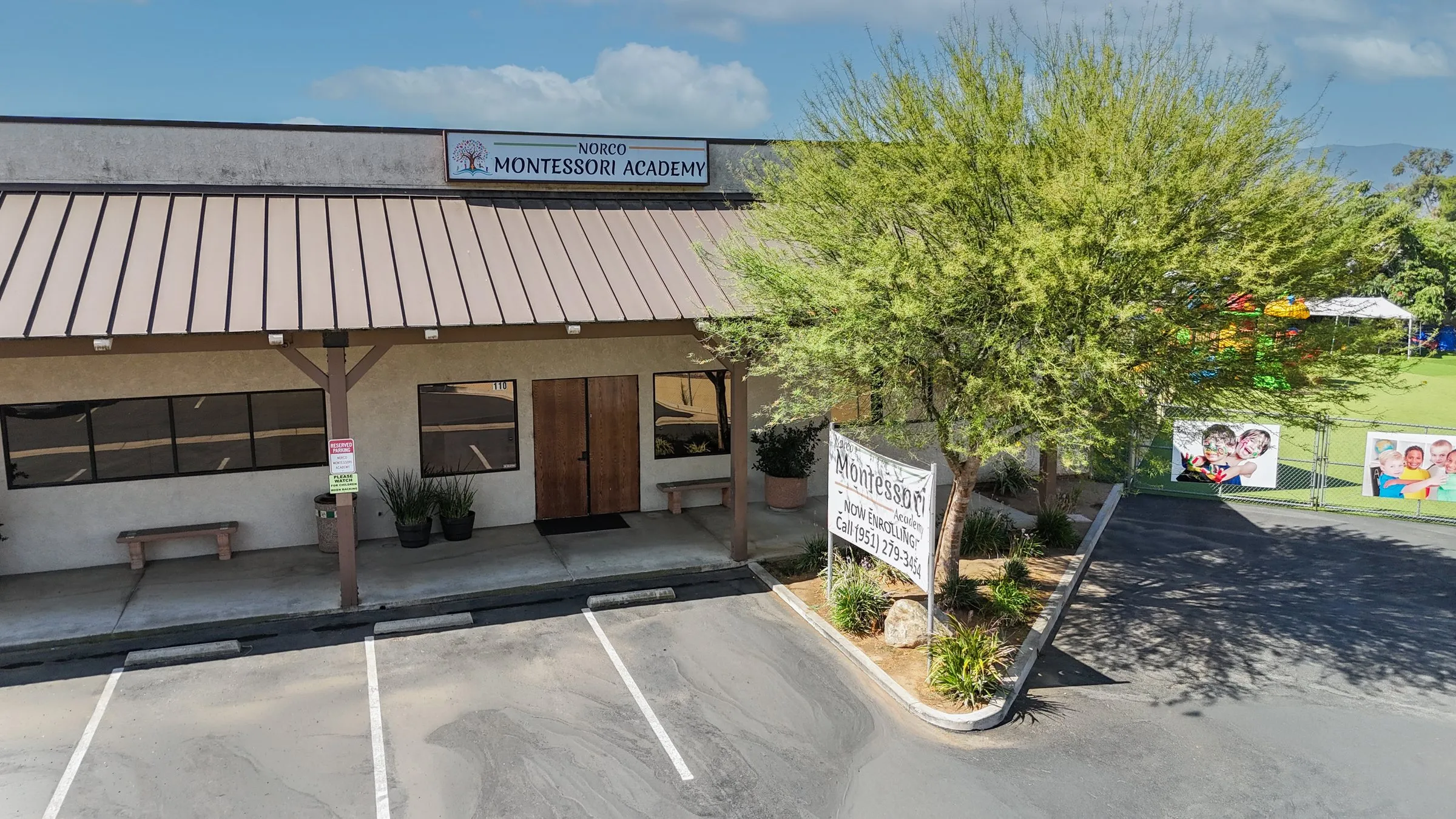 The front entrance of Norco Montessori Academy on Hamner Avenue, with its sign above the covered walkway.